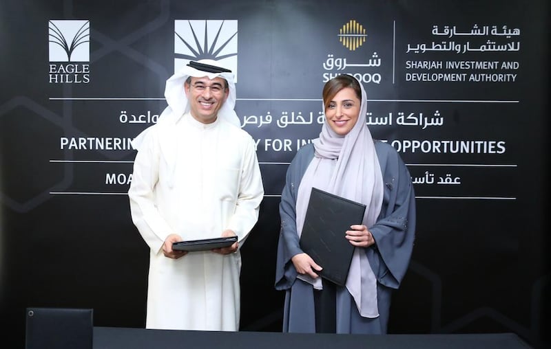 Shurooq’s chairwoman Sheikha Bodour Al Qasimi, left, with the Emaar chief executive Mohamed Alabbar during the ceremony for the creation of Omran Properties. Courtesy Shurooq