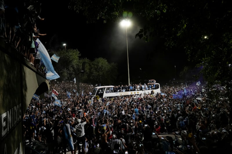 Fans welcome home the Argentine football team that defeated France on Sunday to win the World Cup. AFP