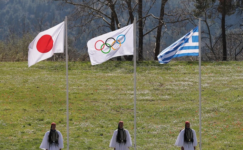 The flag of Japan, the Olympic flag and the flag of Greece during the ceremony. Reuters