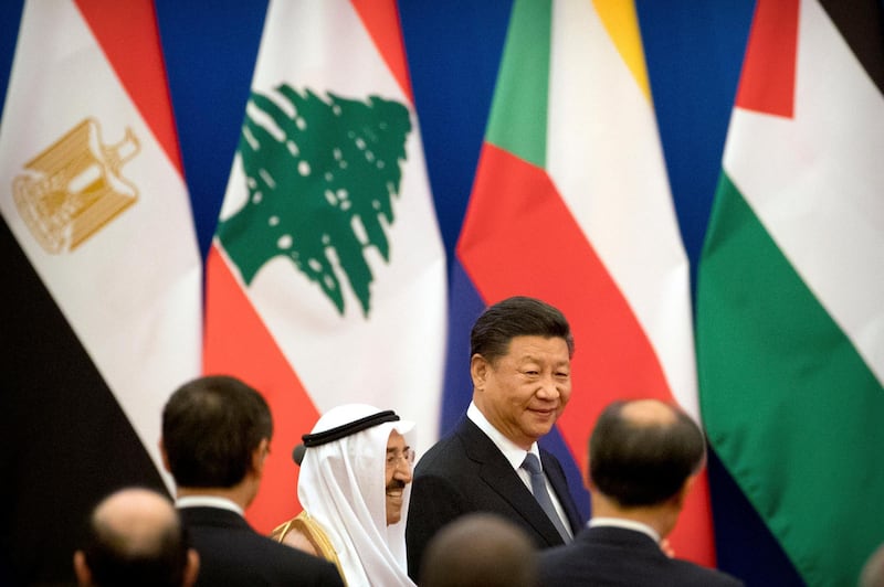 Kuwait's ruling emir, Sheikh Sabah Al Ahmad Al Sabah, center left, and Chinese President Xi Jinping arrive for the opening session of the 8th Ministerial Meeting of the China-Arab States Cooperation Forum in Beijing, Tuesday, July 10, 2018. China's President Xi Jinping has pledged more than $23 billion in lines of credit, loans and humanitarian assistance to Arab countries in a major push for influence in the region. (AP Photo/Mark Schiefelbein)