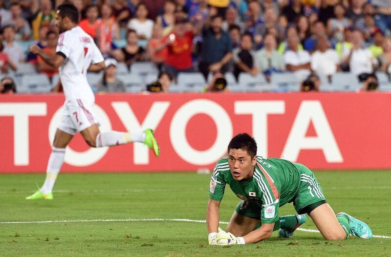 Japan goalkeeper Eiji Kawashima, right, reacts as Ali Mabkhout, left, celebrates scoring the opener to put UAE 1-0 ahead on Friday in the Asian Cup quarter-finals. Craig Golding / AFP