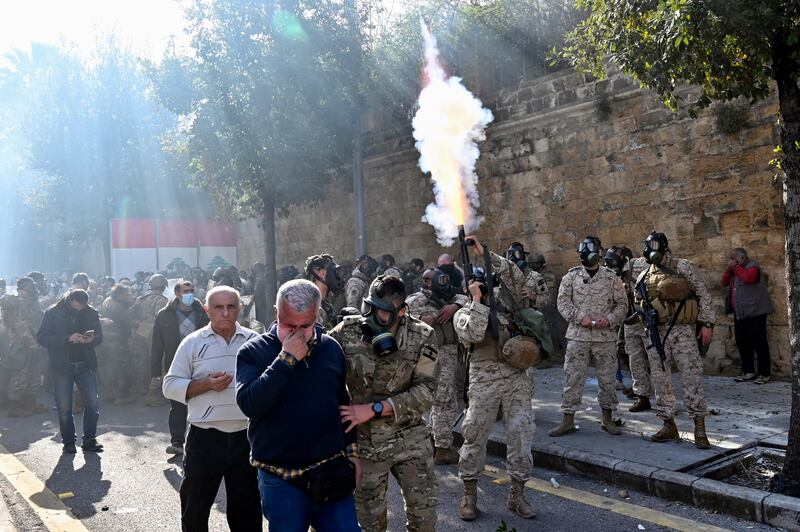 A Lebanese soldier fires tear gas during a protest by retired members of Lebanon's security forces outside the government palace in Beirut. EPA