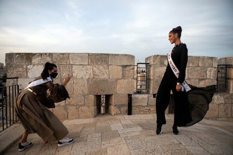 Miss Universe contestants take photos of each other. Reuters