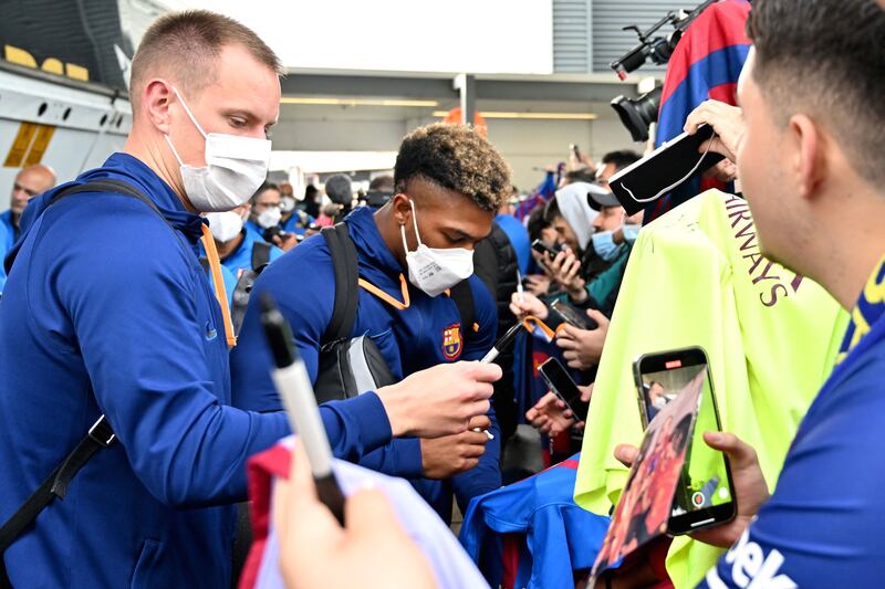 Marc-Andre ter Stegen and Adama Traore sign autographs upon arriving at Sydney International Airport. AFP