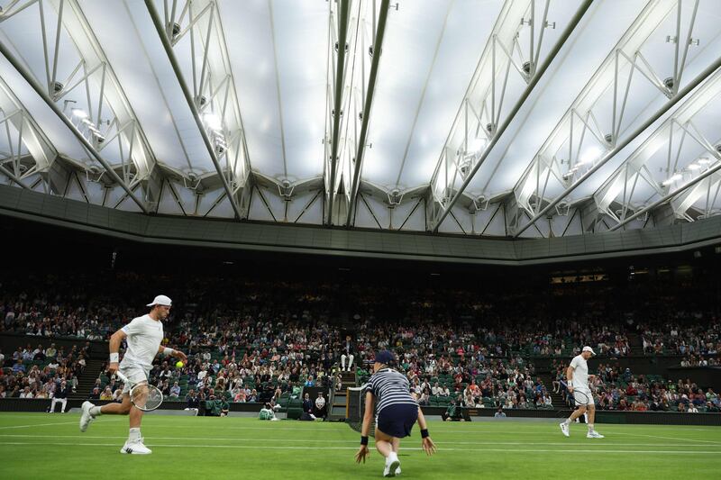 Andy Murray and James Duckworth during their Wimbledon first round match. AFP