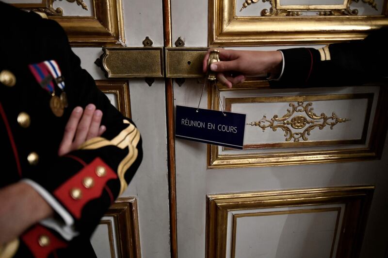 An 'ongoing meeting' sign on a door at the Matignon Hotel in Paris as the French prime minister holds an inter-ministerial meeting regarding the supply of fuel. AFP