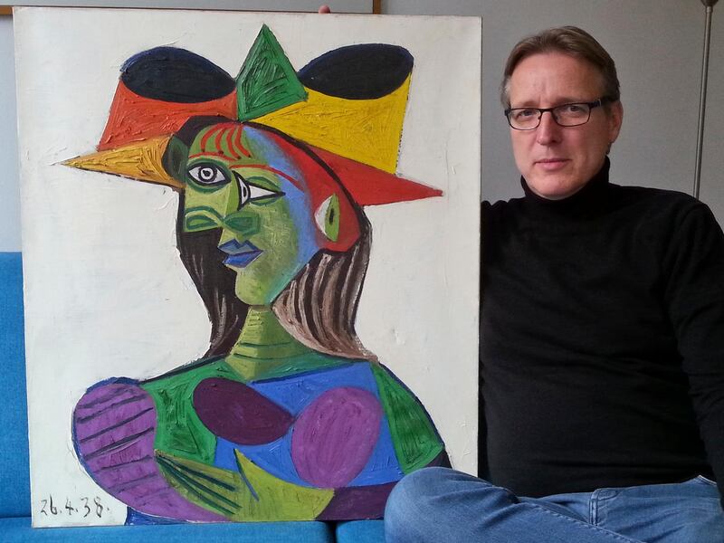 This image released on Tuesday March 26, 2019 by Arthur Brand, shows Dutch art detective Arthur Brand with "Buste de Femme", a recovered Picasso painting. The painting was stolen from a wealthy Saudi's yacht 20 years ago. Arthur Brand, whose previous finds include a pair of bronze horses sculpted for Adolf Hitler, said Tuesday that he took possession a couple of weeks ago of the 1938 painting "Buste de Femme" after trailing it for years through the Amsterdam underworld. He has since returned the work, which he estimates to be worth some 25 million euros ($28 million) to an insurance company. (Arthur Brand via AP)