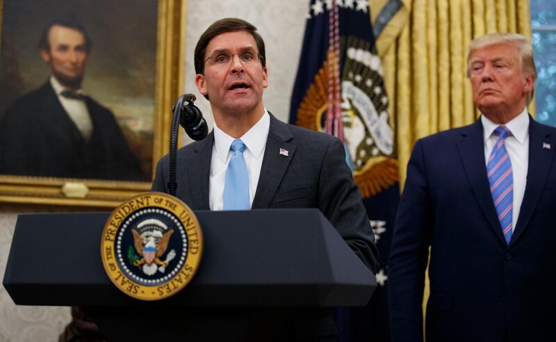 President Donald Trump looks to Secretary of Defense Mark Esper during a ceremony in the Oval Office at the White House in Washington, Tuesday, July 23, 2019. (AP Photo/Carolyn Kaster)