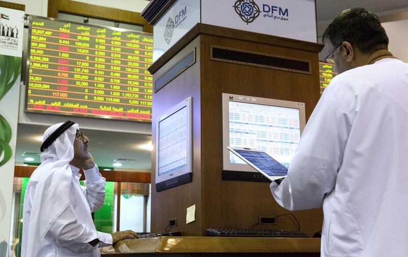 Above, traders at the Dubai Financial Market. Over the past three months, the Dubai index has fallen by 13 per cent. Duncan Chard for The National