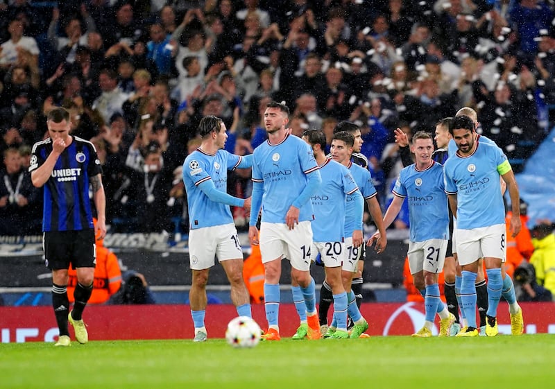 Manchester City players celebrate after FC Copenhagen's Davit Khocholava scores an own goal to put them 3-0 ahead. PA