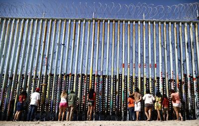 TIJUANA, MEXICO - MARCH 30: People look towards the U.S. on the border barrier, on the U.S.-Mexico border on the beach, on March 30, 2019 in Tijuana, Mexico. U.S. President Donald Trump told reporters yesterday ‚Äúthere's a very good likelihood‚Äù that he will close the U.S. Southern border next week.  (Photo by Mario Tama/Getty Images)