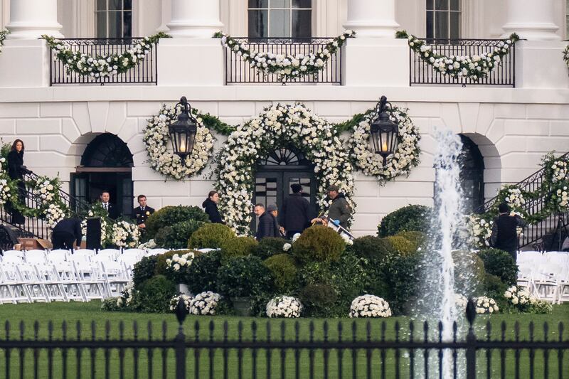 Workers complete final preparations for the ceremony. AP