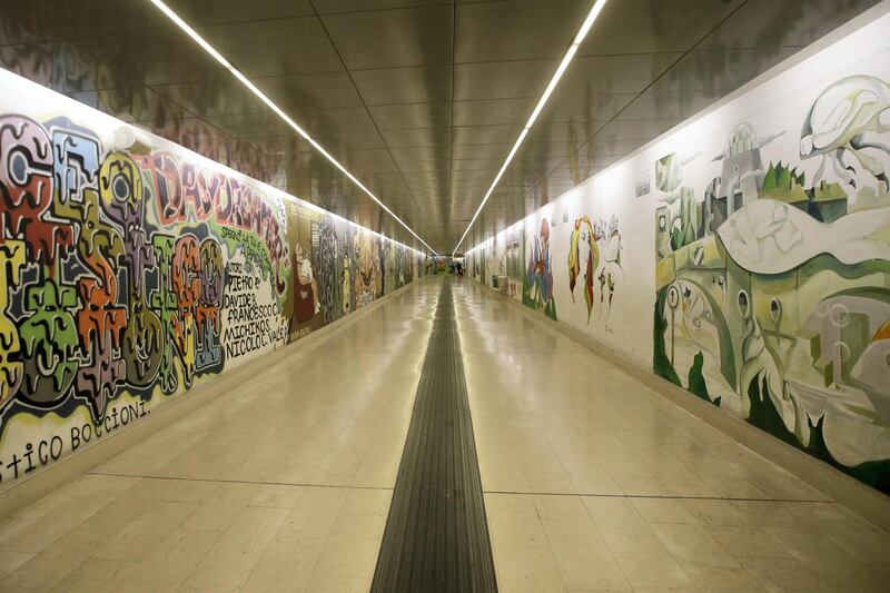 Murals adorn the walls of an empty subway station, in Milan, Friday, Feb. 28, 2020. Due to the COVID-19 virus outbreak in northern Italy, the bustling metropolis of Milan has resembled more of a ghost town lately, as workers stayed home and tourism has dwindled there, and other parts of Italy. (AP Photo/Luca Bruno)