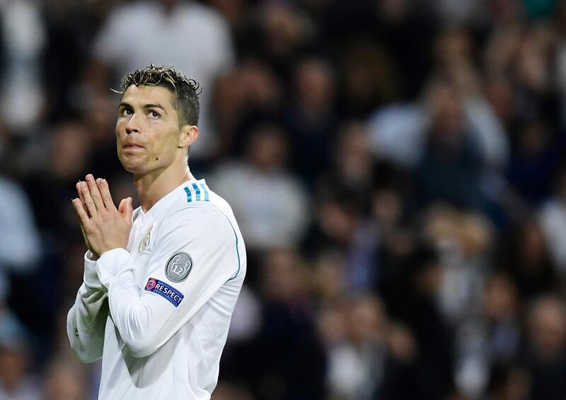 (FILES) In this file photo taken on May 01, 2018 Real Madrid's Portuguese forward Cristiano Ronaldo gestures during the UEFA Champions League semi-final second leg football match between Real Madrid and Bayern Munich at the Santiago Bernabeu Stadium in Madrid on May 1, 2018. Cristiano Ronaldo agreed on June 15, 2018 to pay 18.8 million euros to the Spanish treasury, said a judiciary source.  / AFP / JAVIER SORIANO
