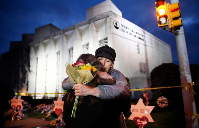 epa07149993 YEARENDER OCTOBER 2018
Two women hug before placing flowers at the Star of David memorial in front of the Tree of Life Synagogue, two days after a mass shooting in Pittsburgh, Pennsylvania, USA, 29 October 2018. Officials report that 11 people were killed by the gunman identified as Robert Bowers who has been charged with hate crimes and other federal charges.  EPA/JARED WICKERHAM