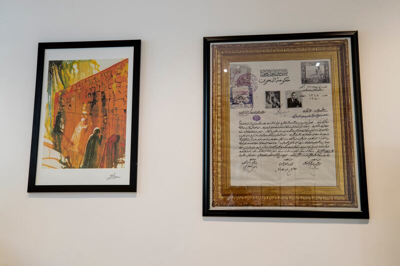 Artwork and manuscripts adorn the walls.