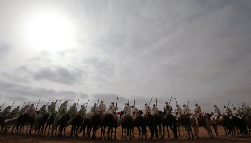 Horsemen ride in a choreographed cavalry during the 14th Tan-Tan Moussem Berber festival in Morocco on Sunday. AFP