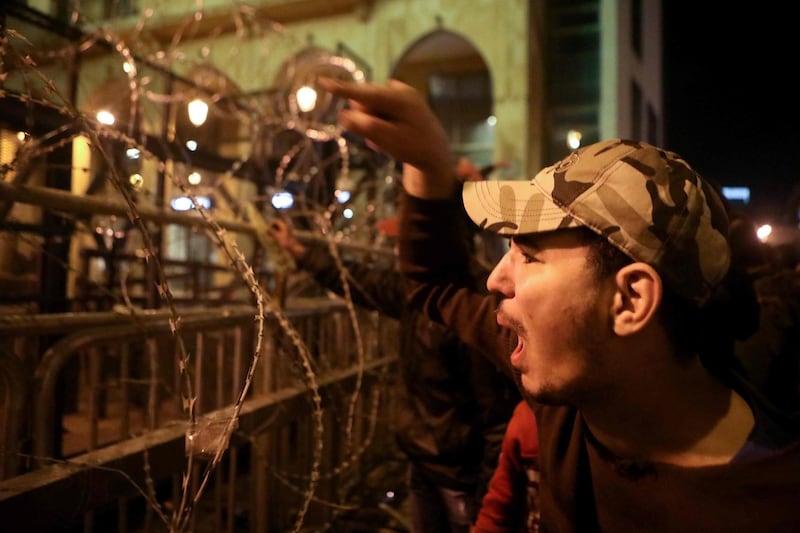 Lebanese anti-corruption protesters shout slogans outside the parliament during a protest in downtown Beirut.  AFP