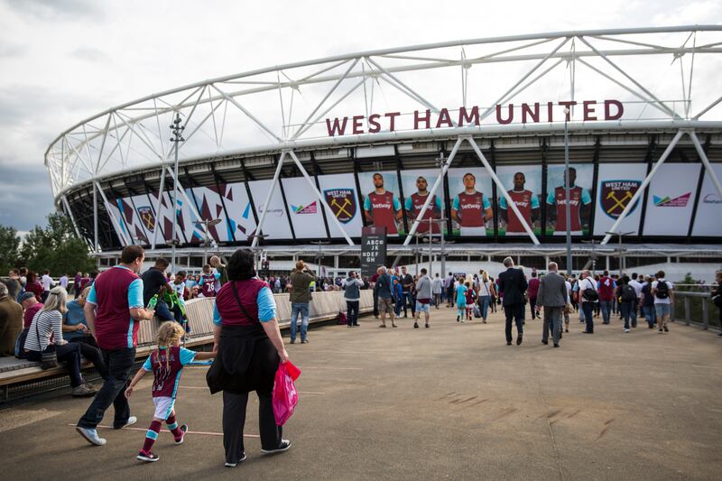 Football fans arrive to watch West Ham United play at their new home, the London Stadium, for the first time in August 2016.