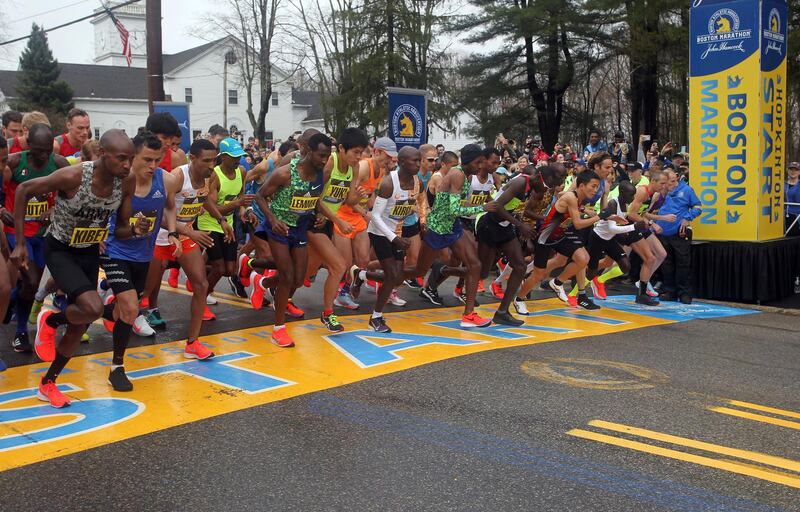 FILE - In this April 15, 2019, file photo, the elite men break from the start of the 123rd Boston Marathon in Hopkinton, Mass. The 2020 Boston Marathon, which was rescheduled to run on Sept. 14th, was canceled Thursday May 28, 2020 for the first time in its 124-year history due to the COVID-19 virus outbreak. (AP Photo/Stew Milne, File)
