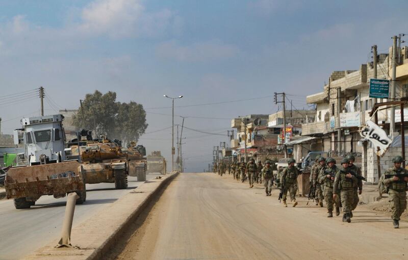 Turkish troops patrol on foot and in military vehicles in the town of Atareb in the rebel-held western countryside of Syria's Aleppo province on February 19, 2020.
 Turkey and Russia were engaged in a fresh war of words today after President Recep Tayyip Erdogan threatened an "imminent" operation in Syria to end the regime's brutal assault on the last rebel enclave. It came as Syrian aid workers issued an urgent call for a ceasefire and international help for nearly a million people fleeing the regime onslaught in the country's northwestern Idlib province -- the biggest wave of displaced civilians in the nine-year conflict. / AFP / Aref TAMMAWI
