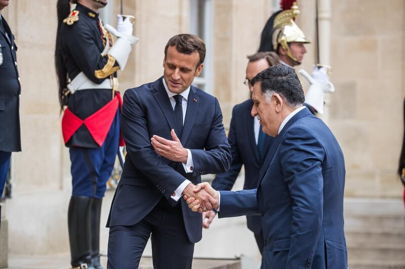 epa07555412 French President Emmanuel Macron (L) shakes hand with the Chairman of the Presidential Council of Libya, Fayez al-Sarraj (R) prior to their meeting at the Elysee Palace in Paris, France, 08 May 2019.  EPA/CHRISTOPHE PETIT TESSON