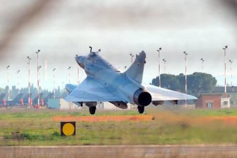 epa02657002 An UAE (United Arab Emirates) fighter plane lands on the tarmac at the Nato airbase in Decimomannu, Sardinia island, Italy, 27 March 2011. Since March 19, a US-led coalition that includes Britain and France has been taking out Libyan air defences and ground forces in order to enforce a United ations-imposed no-fly zone to protect civilians. Qatar and the United Arab Emirates have so far been the only Arab countries to actively join the international military action by contributing jets.  EPA/GIUSEPPE UNGARI *** Local Caption ***  02657002.jpg