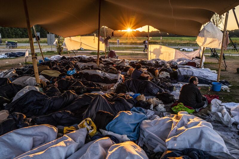 Asylum seekers sleep outside the gate at the application centre in Ter Apel, the Netherlands. EPA