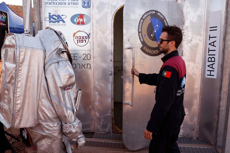 Dressed in a spacesuit, an astronaut prepares to enter the sealed "habitat" that simulates life on Mars. AFP