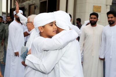 Worshippers greet each other after Eid prayers in Dubai. Pawan Singh / The National