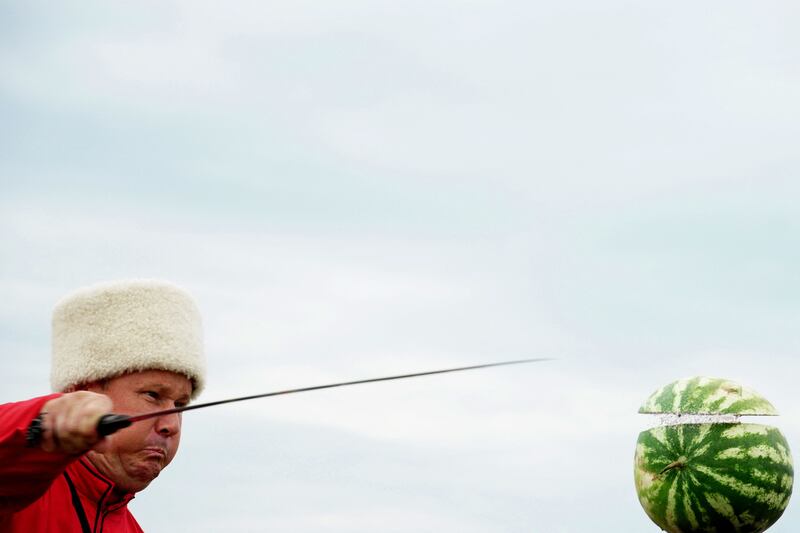 A Cossack slashes a watermelon at a sabre competition in Novosvetlovsky in Russia's Rostov region. AFP