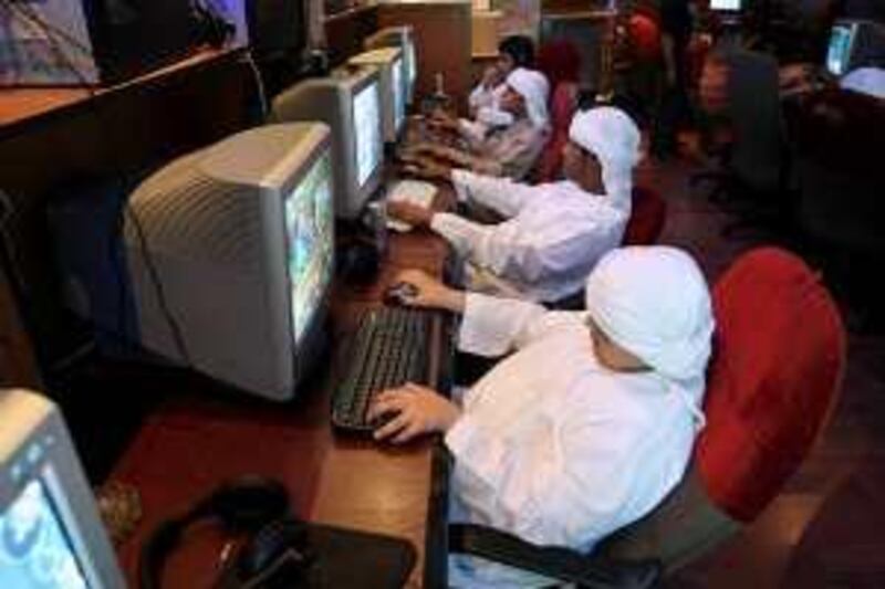 Abu Dhabi - October 9, 2008 - Young boys surf the internet at The Warrior internet in Abu Dhabi October 9, 2008. ( Jeff Topping / The National 2 *** Local Caption ***  na00-YouthSetup2.jpgna00-YouthSetup2.jpg