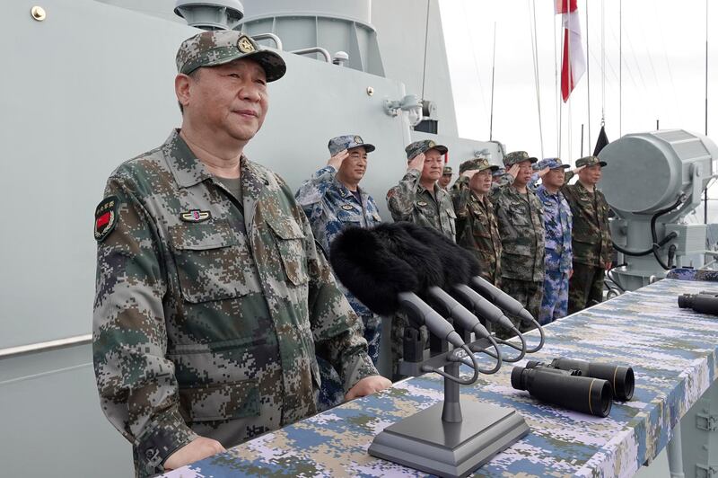 FILE - In this April 12, 2018, file photo released by Xinhua News Agency, Chinese President Xi Jinping speaks after reviewing the Chinese People's Liberation Army (PLA) Navy fleet in the South China Sea. Xi is calling on the PLA to better prepare for combat, amid tensions over Taiwan and the South China Sea. Xi told a meeting of top military leaders Saturday, Jan. 5, 2019, that the 3-million-strong PLA needs to prepare for a â€œcomprehensive military struggle from a new starting point,â€ according to state media reports. (Li Gang/Xinhua via AP, File)