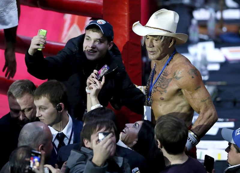 Mickey Rourke, centre, reacts after his fight against US boxer Elliot Seymour in Moscow. Yuri Kochetkov / EPA