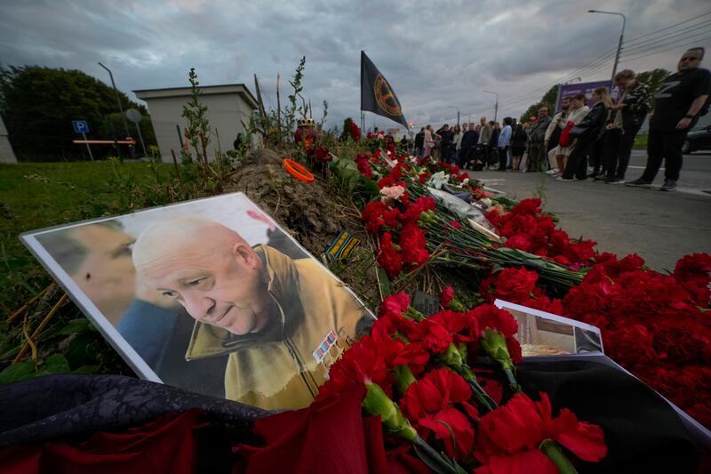 A portrait of the owner of the private military company Wagner Group, Yevgeny Prigozhin, lies in an informal memorial in St Petersburg. AP