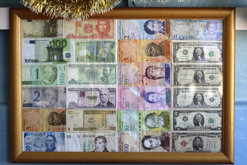Bank notes from various countries are displayed on the wall of a beverage shop Havana. Desmond Boylan / AP Photo