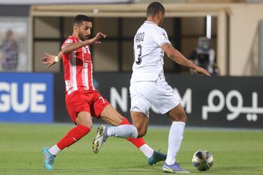 Jazira's forward Ali Mabkhout (L) vies for the ball with Shabab's defender Iago Santos during the AFC Champions League group B match between Saudi Arabia's Al-Shabab and UAE's Al-Jazira on April 11, 2022, at the Prince Faisal Bin Fahd stadium in the capital Riyadh.  (Photo by AFP)