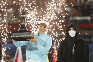 Sheikha Latifa bint Mohammed bin Rashid al-Maktoum (R) the chairperson of the Dubai Culture and Arts Authority presents the winner's trophy to Jelena Ostapenko of Latvia after the final match of the WTA Dubai Duty Free Tennis Championship against Veronika Kudermetova of Russia in the Gulf emirate of Dubai on February 19, 2022.  (Photo by Karim SAHIB  /  AFP)