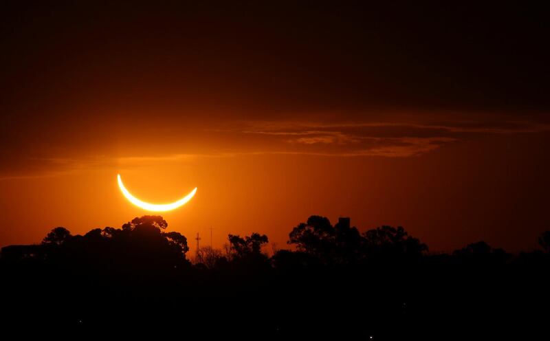 The moon passes in front of the setting sun during a total solar eclipse in Buenos Aires, Argentina. AP Photo