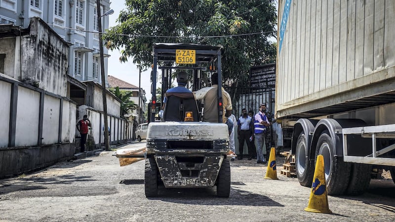 Forklift drivers transport a dead body wrapped in a bloodied sheet in Colombo, Sri Lanka, April 24, 2019. Jack Moore / The National