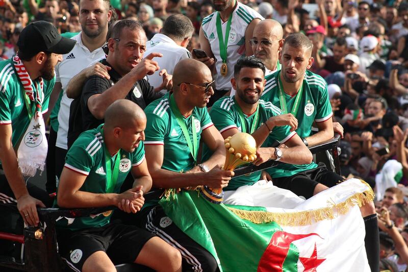 Captain Riyad Mahrez, second right, and his Algeria teammates, celebrate with fans in Algiers after winning the Africa Cup of Nations. AFP