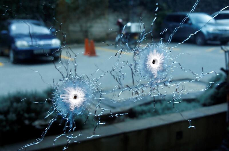 A window damaged by bullets has escaped shattering. Baz Ratner / Baz Ratner