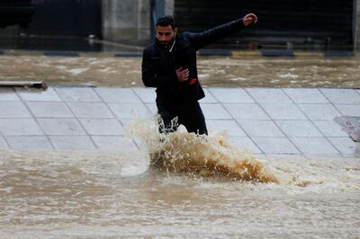 A man crosses a flooded street during heavy rains in Amman, Jordan, February 28, 2019. REUTERS/Muhammad Hamed