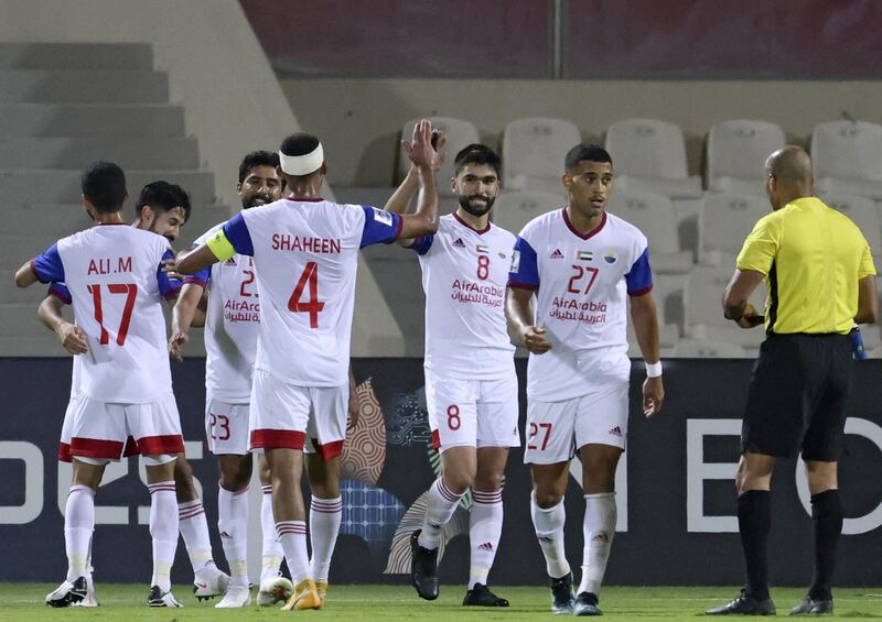 Sharjah's players celebrate their goal during the AFC Champions League group B match between UAE's Sharjah FC and Iraq's Al-Quwa Al-Jawiya on April 14, 2021, at the Sharjah football stadium in the Emirati city. / AFP / Karim SAHIB
