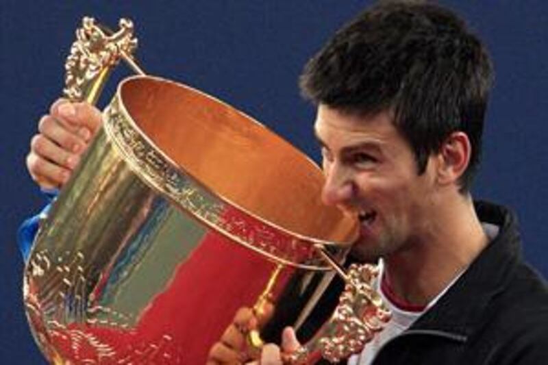Novak Djokovic with the winning trophy after beating Marin Cilic at the China Open final.