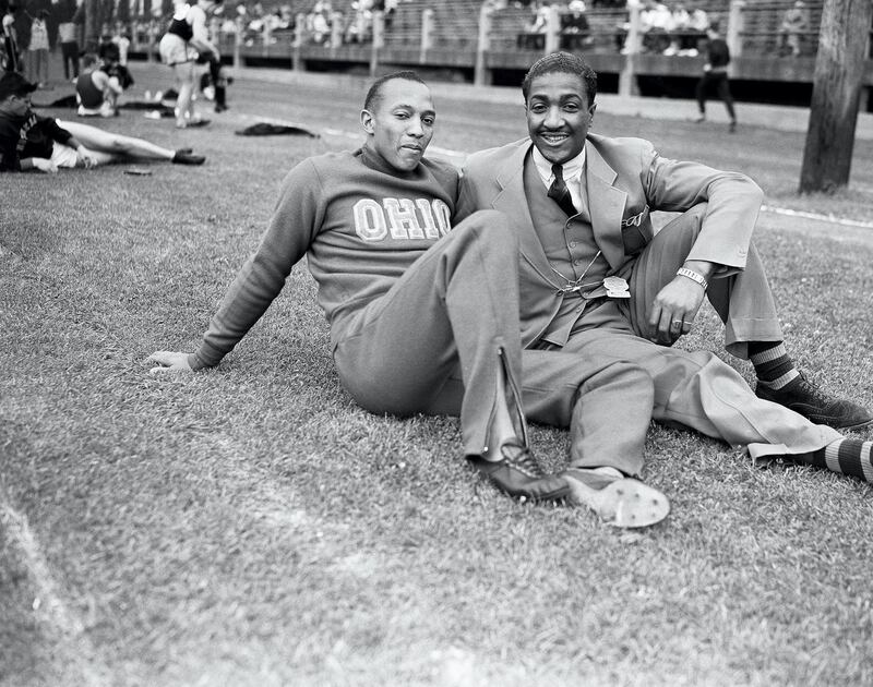 Jesse Owens of Ohio State University and Ralph Metcalfe, right, of Milwaukee, formerly of Marquette University, two of the country’s star African Amercan athletes, talk about cinder affairs during the Central Intercollegiate Conference track and field meet in Milwaukee on June 5, 1936. Metcalfe looked on as Owens sped 100 yards in 9.7 seconds, 2/10 second slower than meet mark set by Metcalfe in 1933. (AP Photo/Paul Cannon)