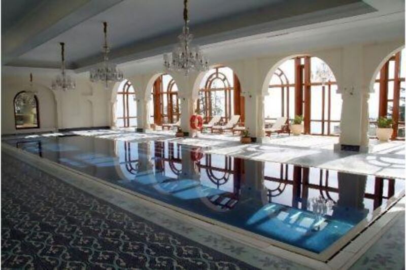 East India Hotels, a hospitality major that operates the Oberoi group of hotels, sold a 14.2 per cent stake to Reliance Industries for 10.21bn rupees. Above, The indoor swimming pool at Oberoi's Wildflower Hall in Shimla, India. Adam Majendie/Bloomberg News.