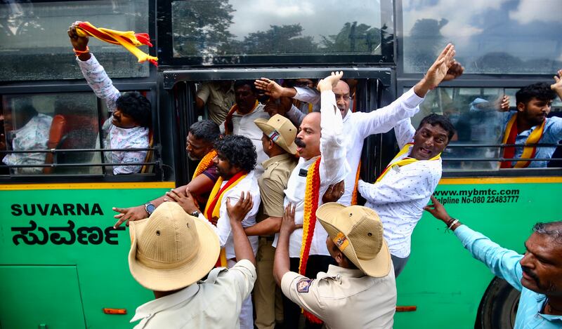 Indian police force pro-Kannada activists into a bus in Bangalore, India. EPA