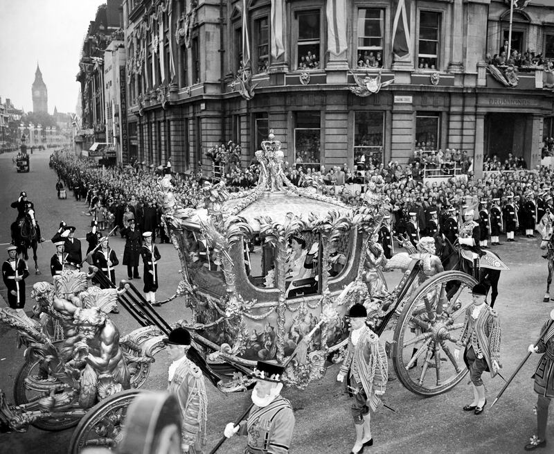 Queen Elizabeth riding with the Duke of Edinburgh in the state coach through Trafalgar Square on the way from Buckingham Palace to Westminster Abbey for her coronation. 