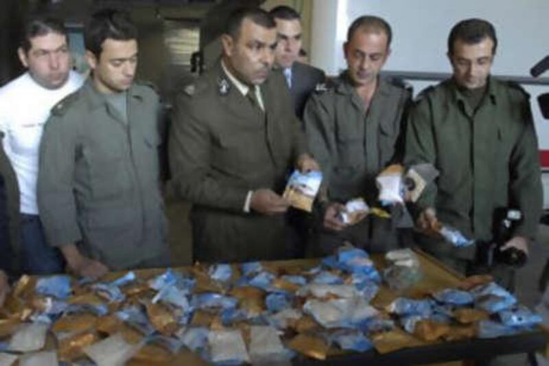 Lebanese customs officers display confiscated drugs of Captagon pills found in a bus, at Beirut Port, in Lebanon, on Nov 26 2007.